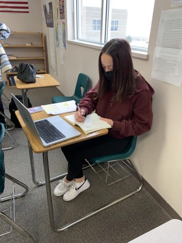 Nothing can deter Isabella DeBoer, 12, from reading and analyzing her book of poetry on Feb. 16. “I’m excited to go super into depth about one poet instead of reading a bunch of different poems from all sorts of different people,” DeBoer said. DeBoer’s poet was Diandra Prema and her biggest worry was how time-consuming this project was going to be and her time management. - 